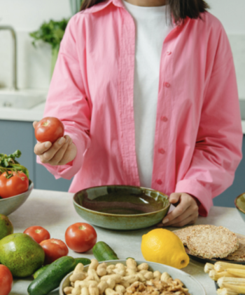 Lady in front of table with fresh vegatables